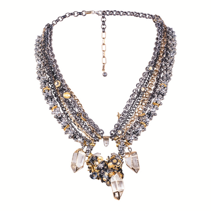 Multistrand necklace with crystals and gold accents on a white background