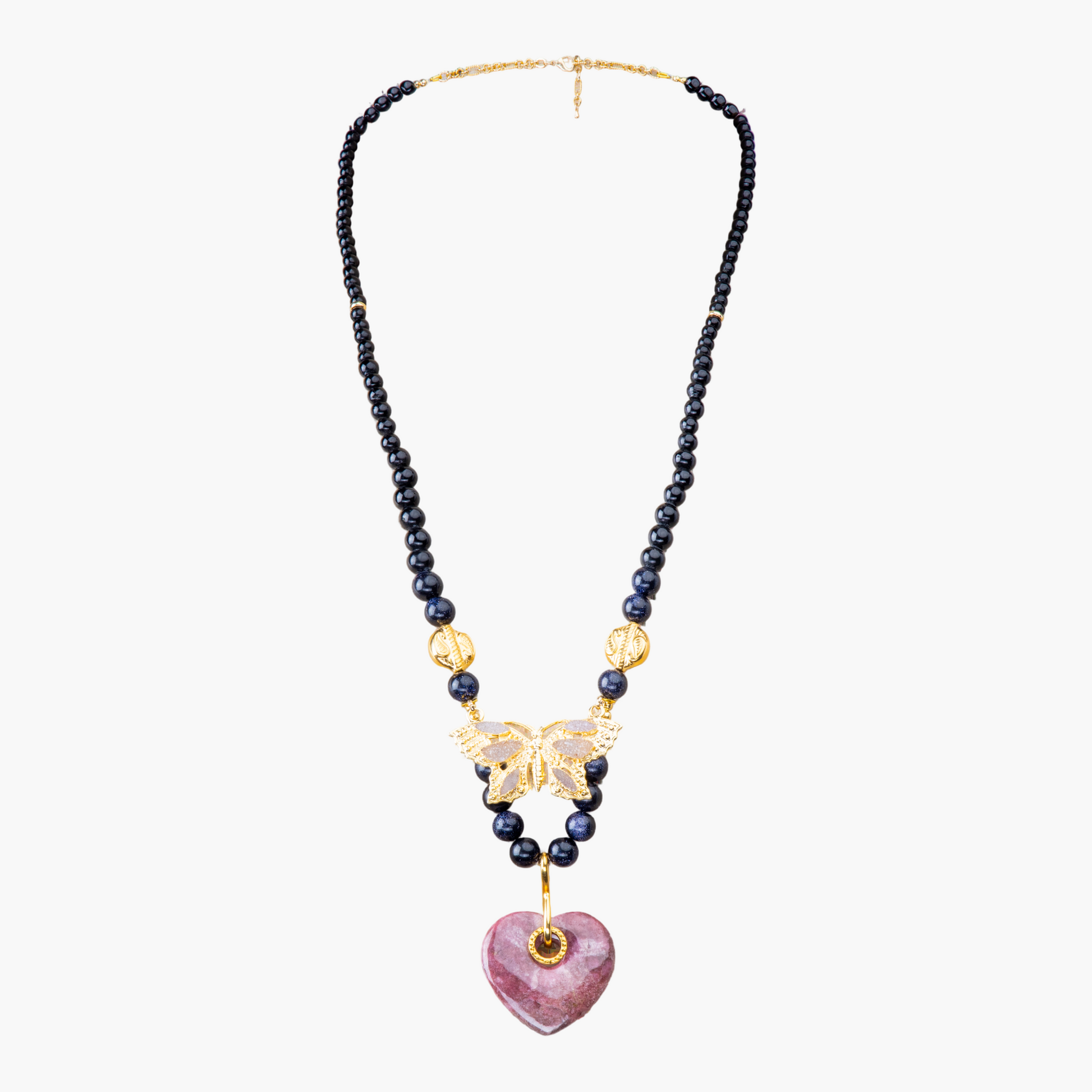 Necklace with beads, gold butterfly, and pink heart pendant on a white background